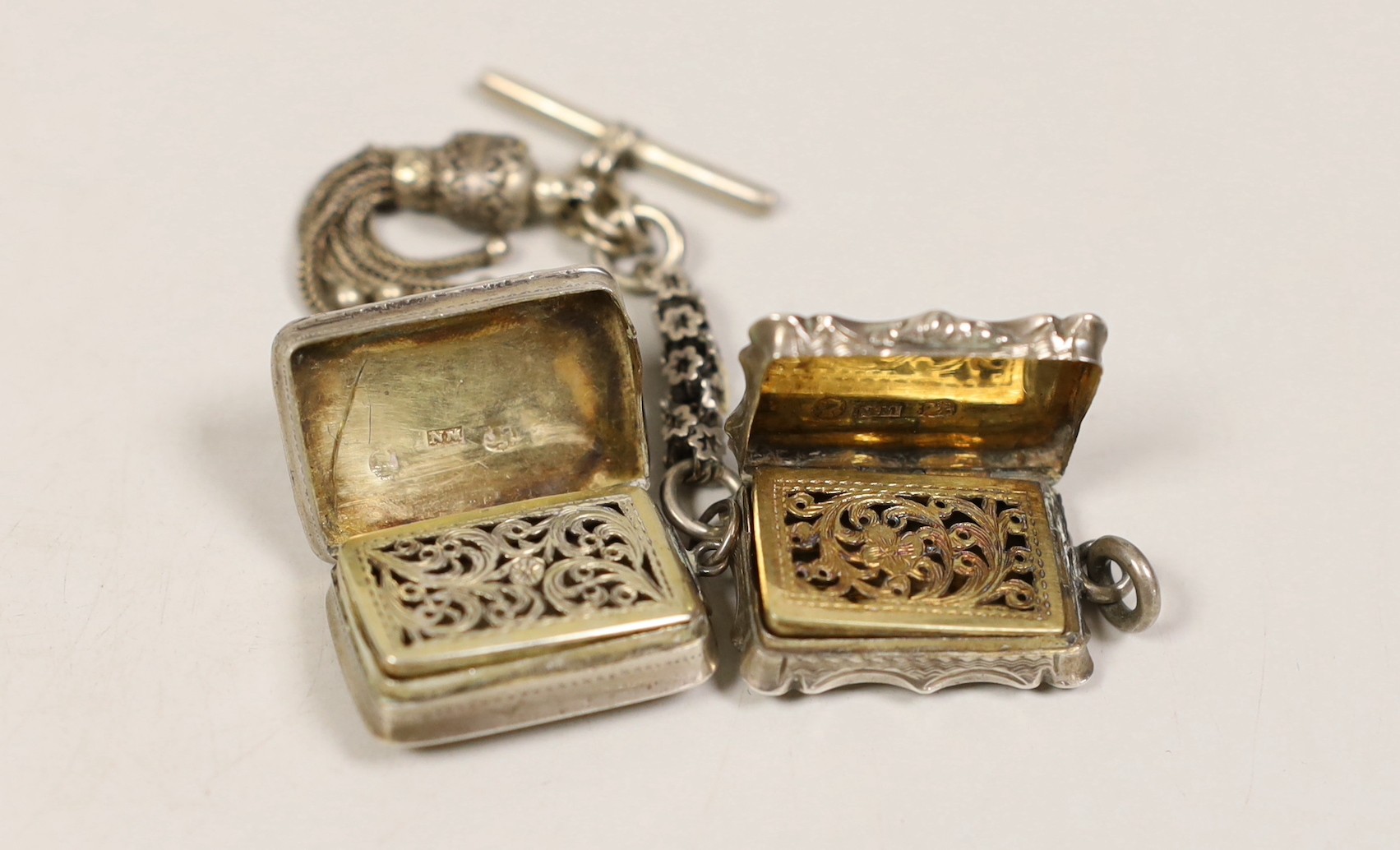 Two small silver vinaigrettes, by Nathaniel Mills, Birmingham, 1843, 23mm and 1831 with tassel fob.